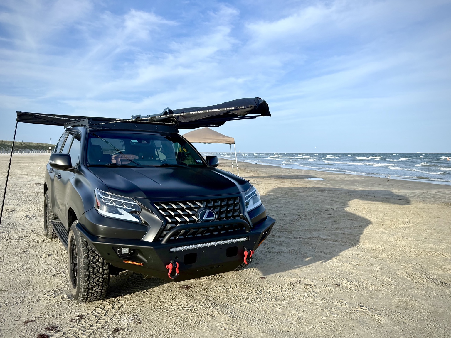 Black Lexus GX 460 overland vehicle at the beach