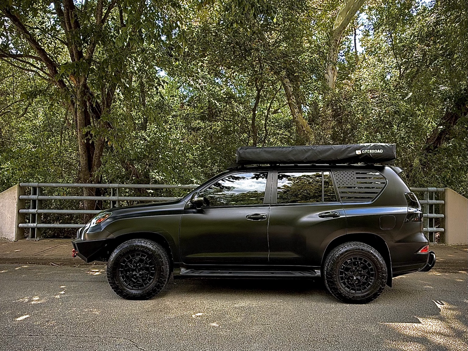 Side profile of black Lexus GX 460 with roof awning